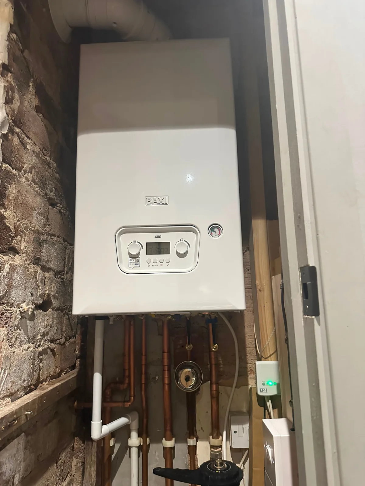 Baxi 400 combi boiler installed on a brick and timber wall during a Fylde Coast boiler replacement