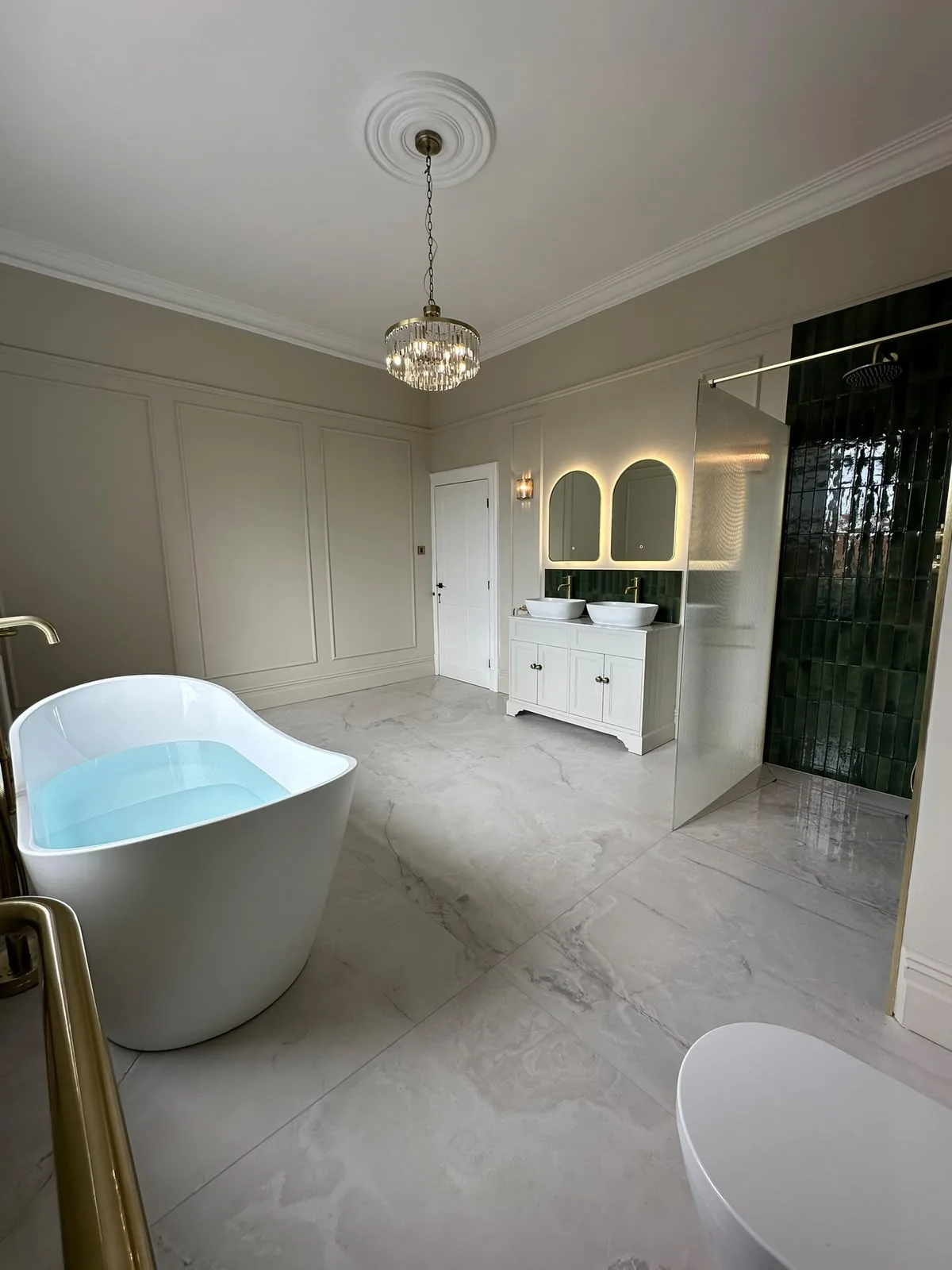 Fylde Coast bathroom renovation with marble-effect floor tiles, freestanding bath, walk-in shower and double vanity