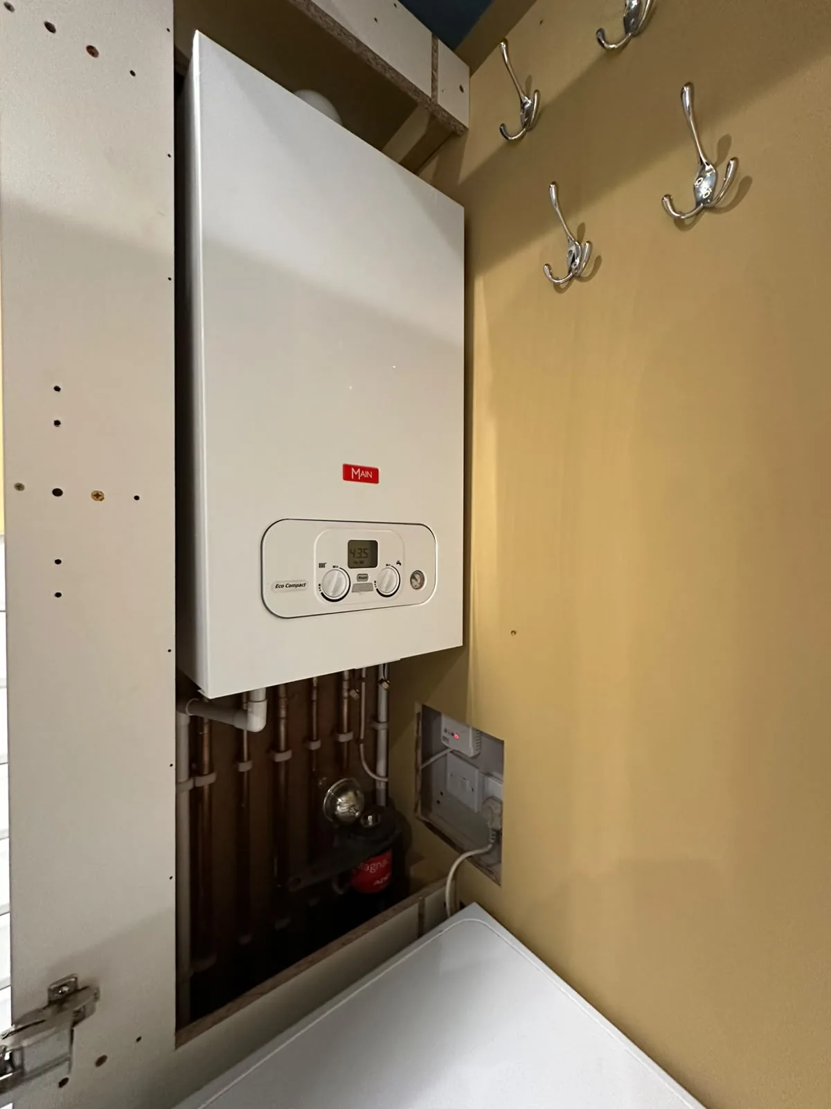 Compact Main Eco combi boiler fitted neatly inside a storage cupboard on a Blackpool boiler installation