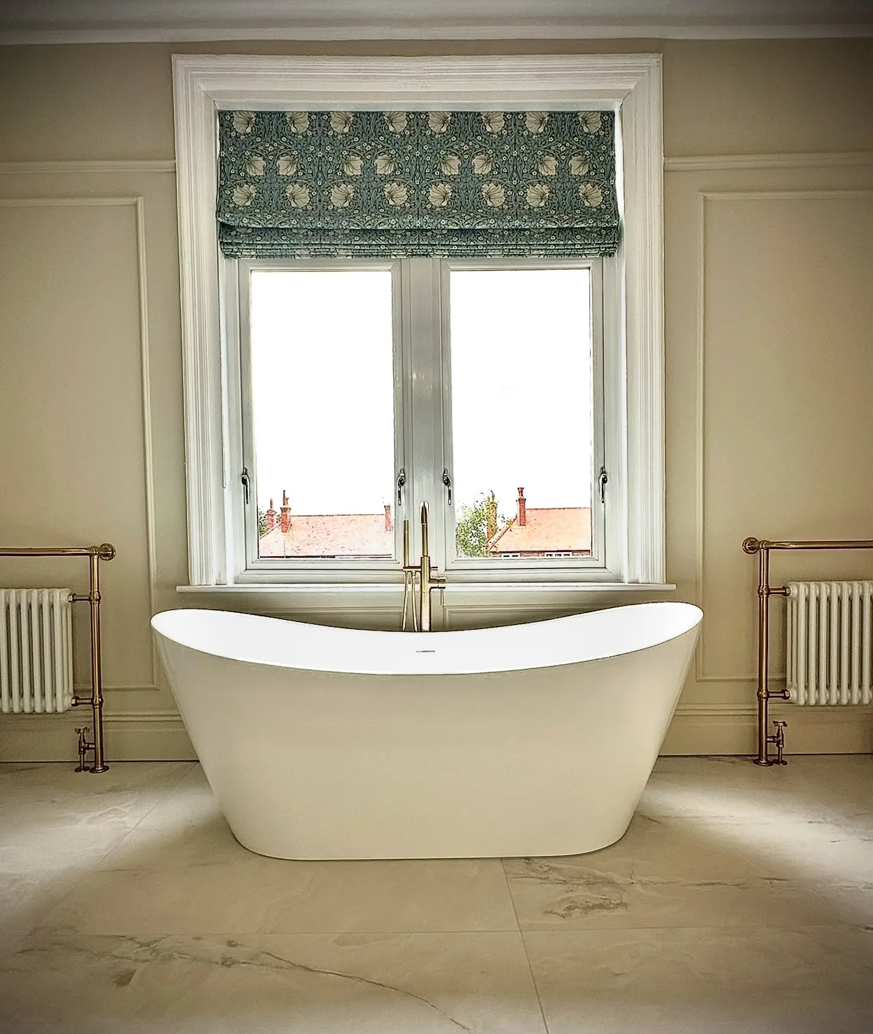 Bathroom renovation in Blackpool with a freestanding bath and traditional column radiators with brass valves