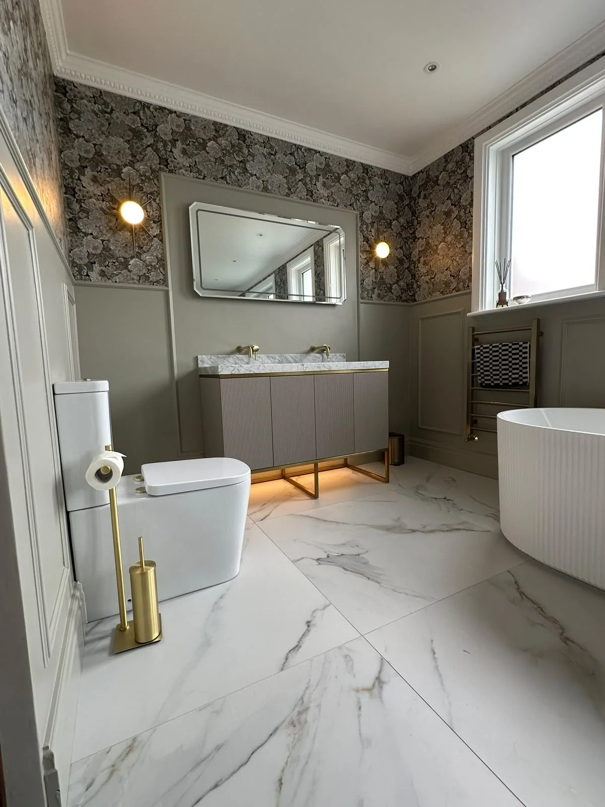 Luxury bathroom renovation on the Fylde Coast with wall panelling, marble-topped double vanity and freestanding bath