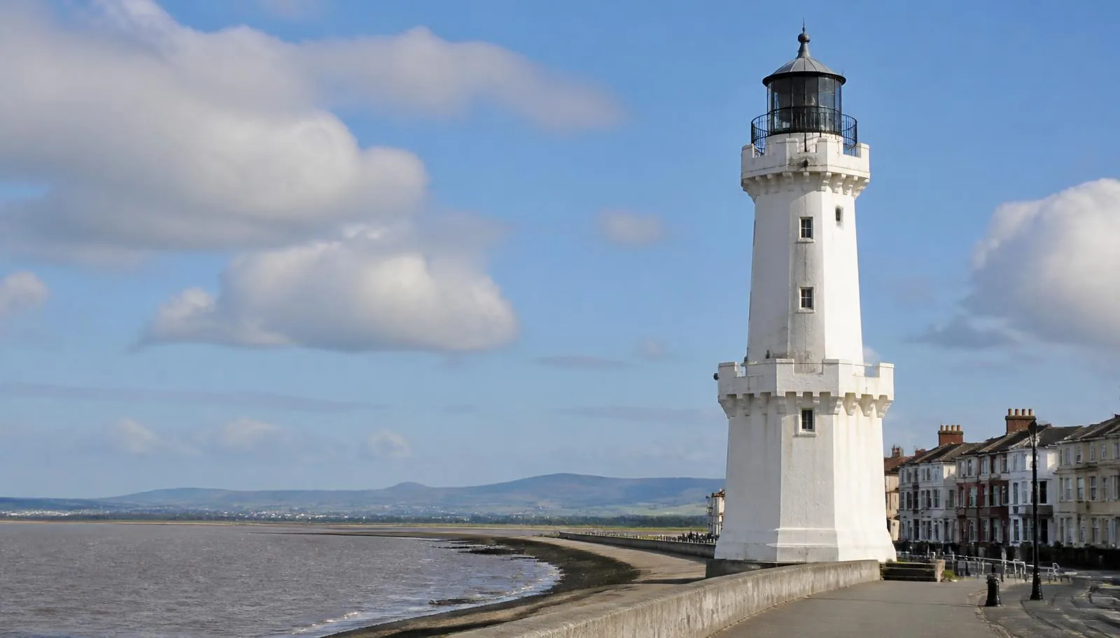 The white Pharos lighthouse on Fleetwood promenade with the Wyre estuary and hills beyond
