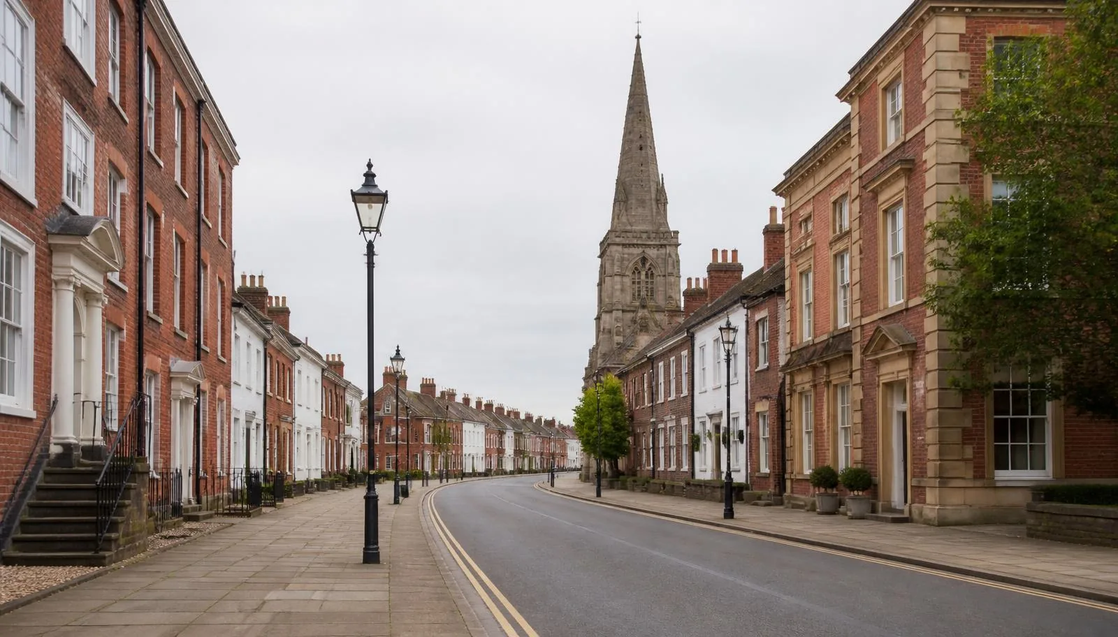 Georgian red brick buildings and the church spire on the main street in Kirkham